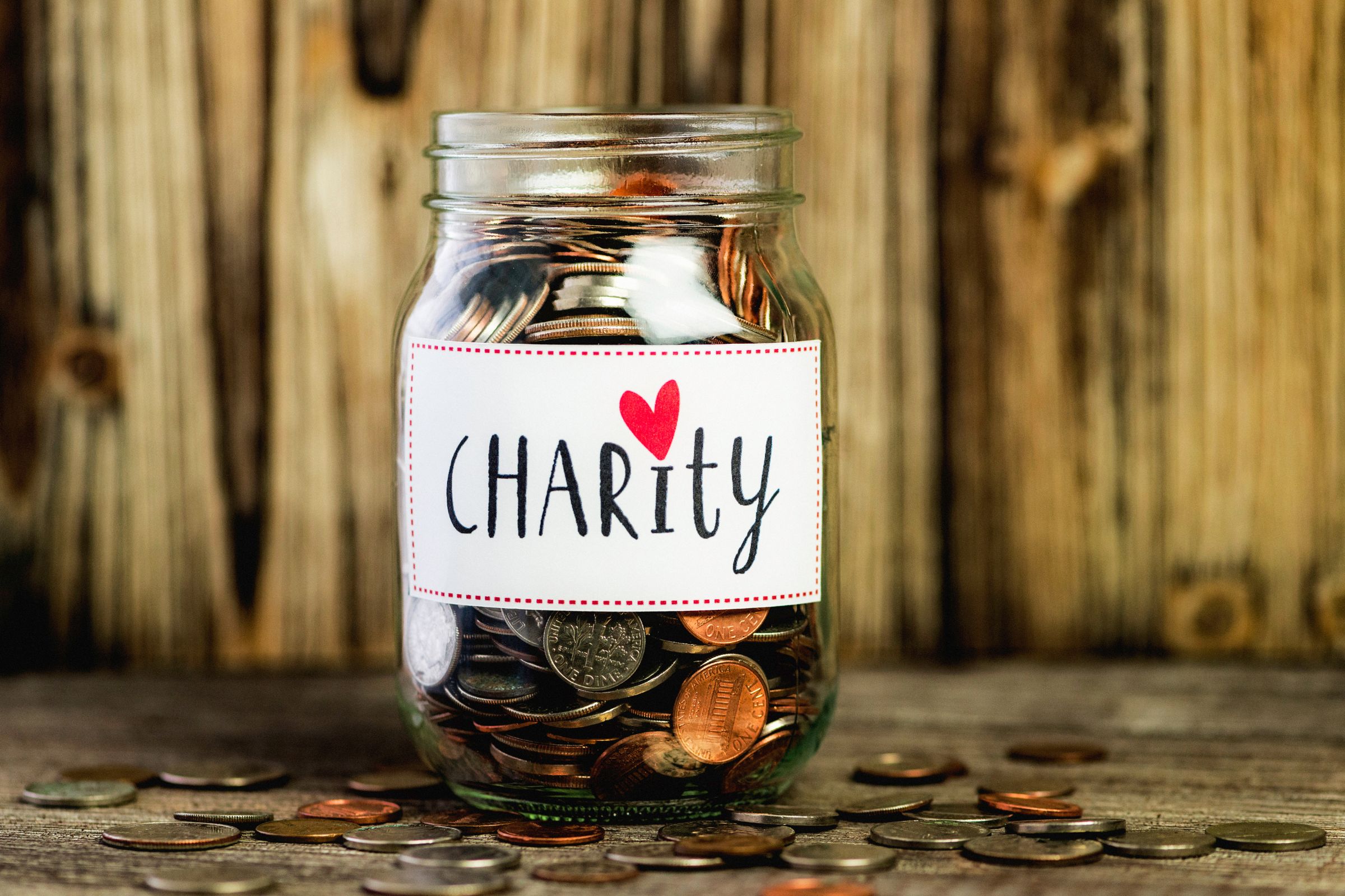 a jar of money with charity written on the front